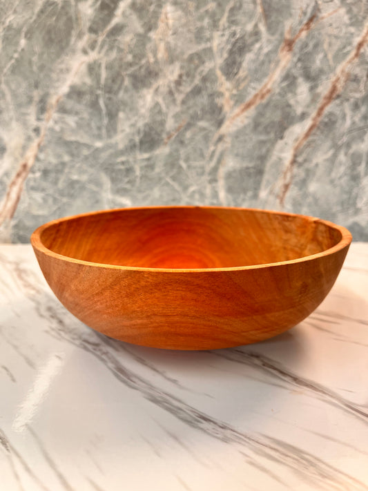 A simple bowl made of eucalyptus wood, measures seven three-quarter inches by two and three-quarter inches